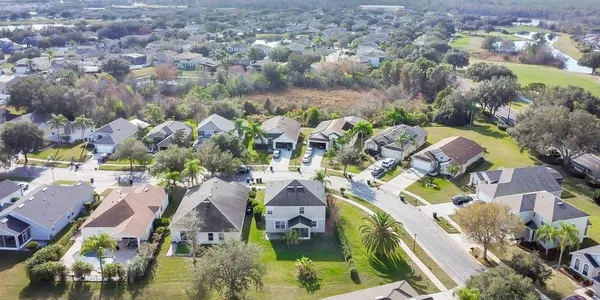 an aerial view of a house with a yard