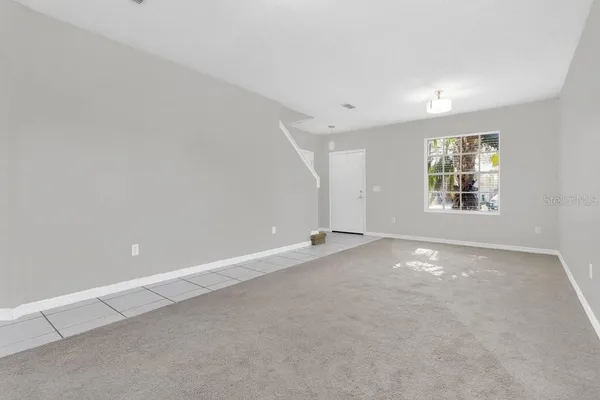 an empty room with a windows and closet