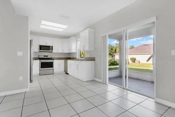 a kitchen with a stove a sink and a refrigerator