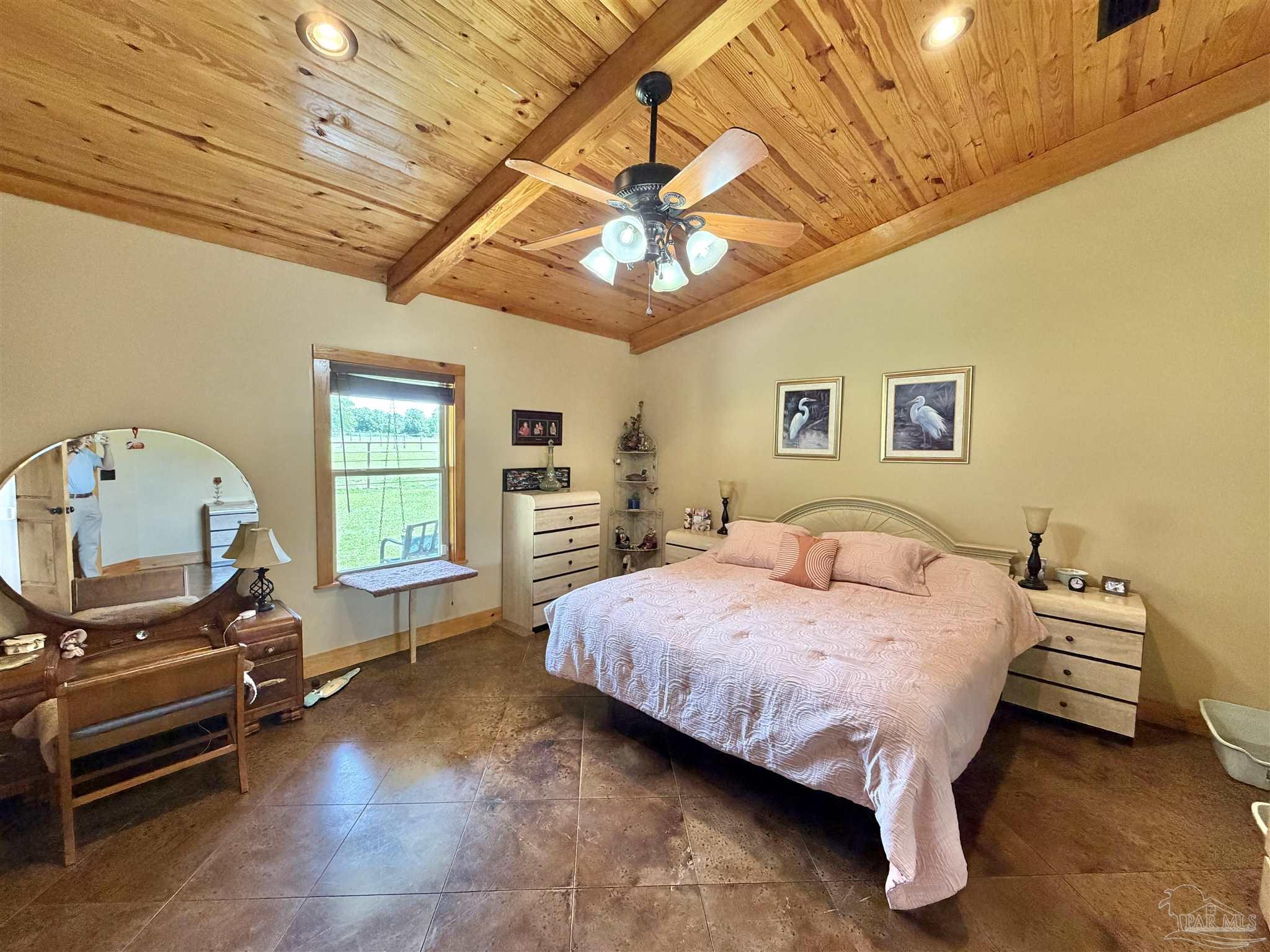 145 Tower Road Uriah, AL 36480 - Photo 12 of 72 a bedroom with a bed a chandelier and a flat screen tv