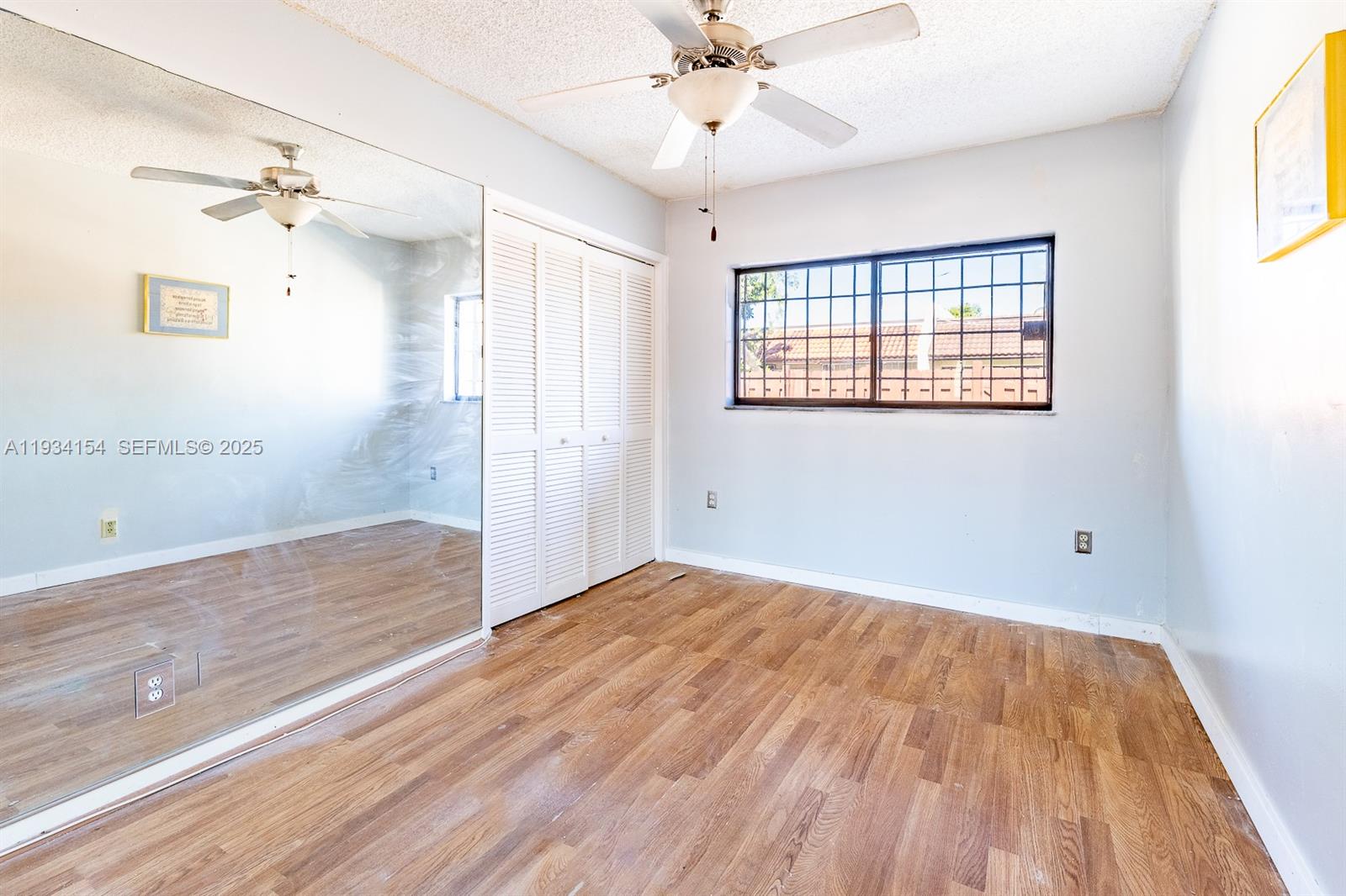 6491 Northwest 190th Terrace Hialeah, FL 33015 - Photo 17 of 28 wooden floor in an empty room with a window