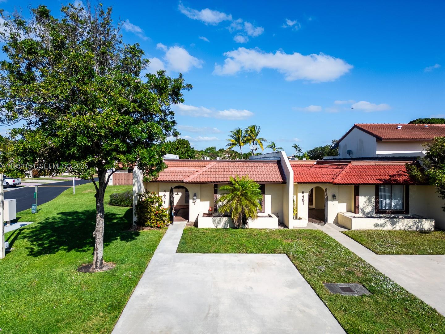 6491 Northwest 190th Terrace Hialeah, FL 33015 - Photo 2 of 28 a front view of a house with a yard