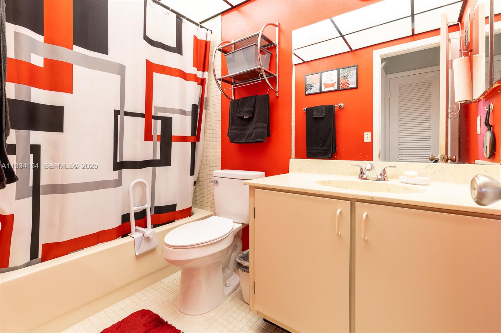 6491 Northwest 190th Terrace Hialeah, FL 33015 - Photo 22 of 28 a bathroom with a sink and mirror with toilet