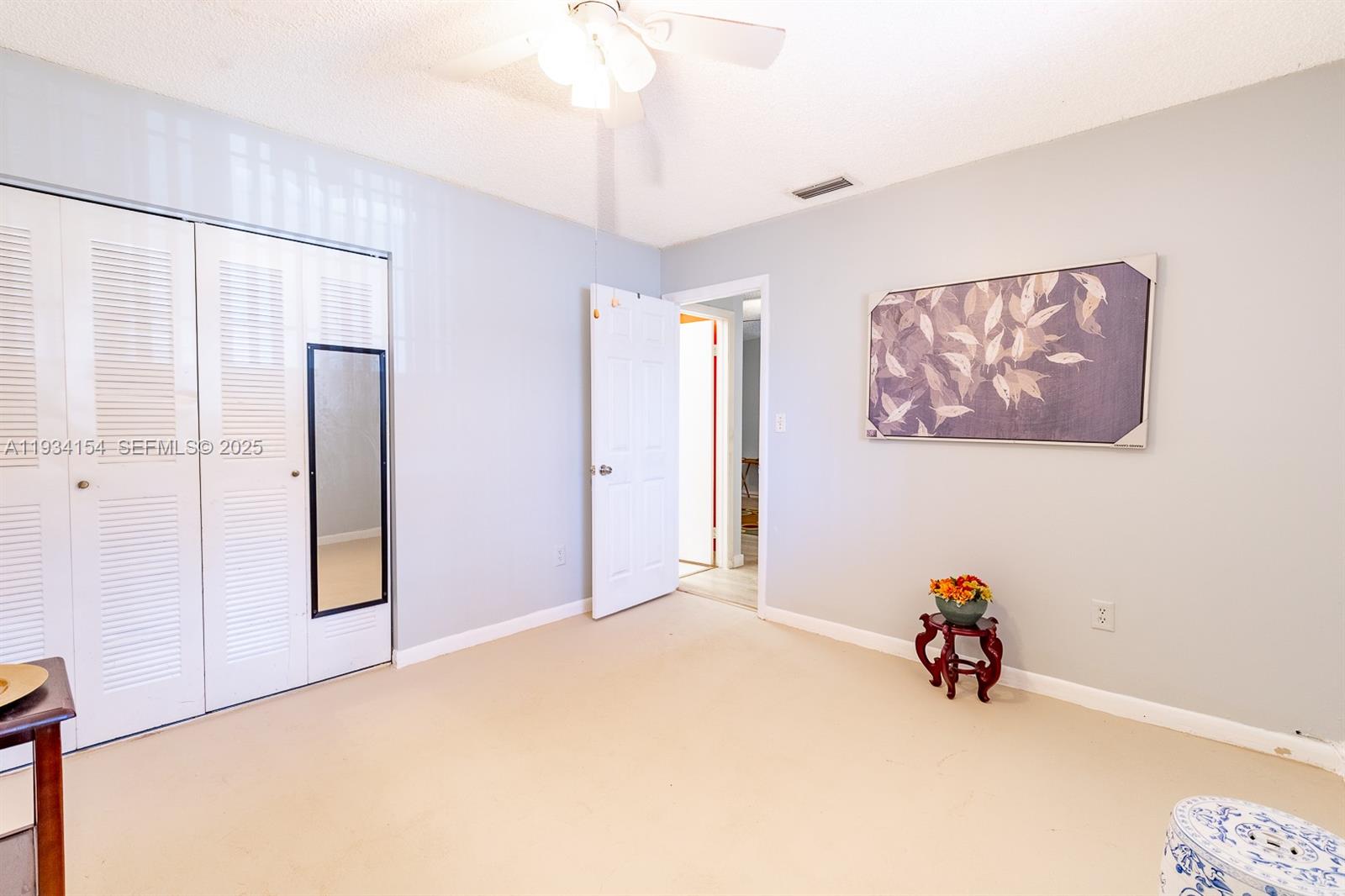 6491 Northwest 190th Terrace Hialeah, FL 33015 - Photo 24 of 28 a view of a room with cabinet and a ceiling fan