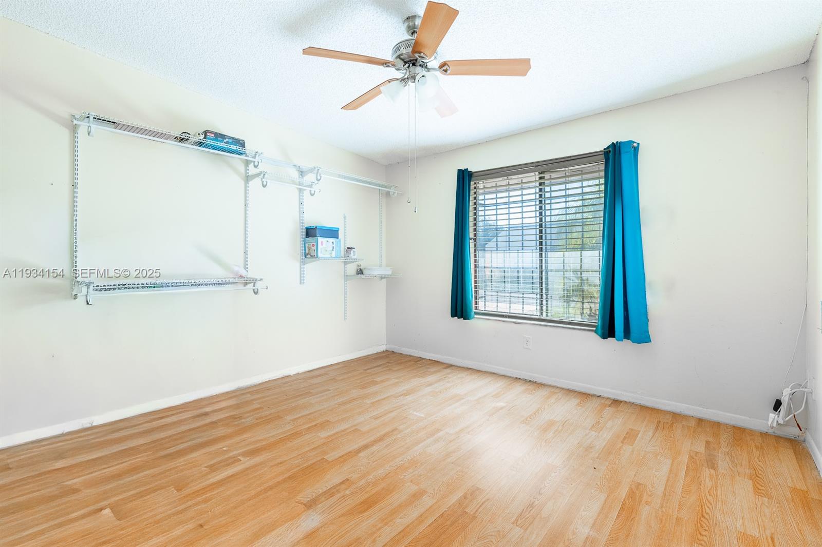 6491 Northwest 190th Terrace Hialeah, FL 33015 - Photo 9 of 28 wooden floor in an empty room with a window
