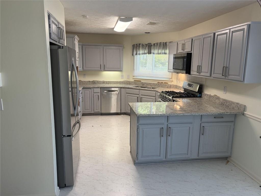 3089 Commons Crossing Snellville, GA 30078 - Photo 4 of 16 a kitchen with a refrigerator sink and cabinets
