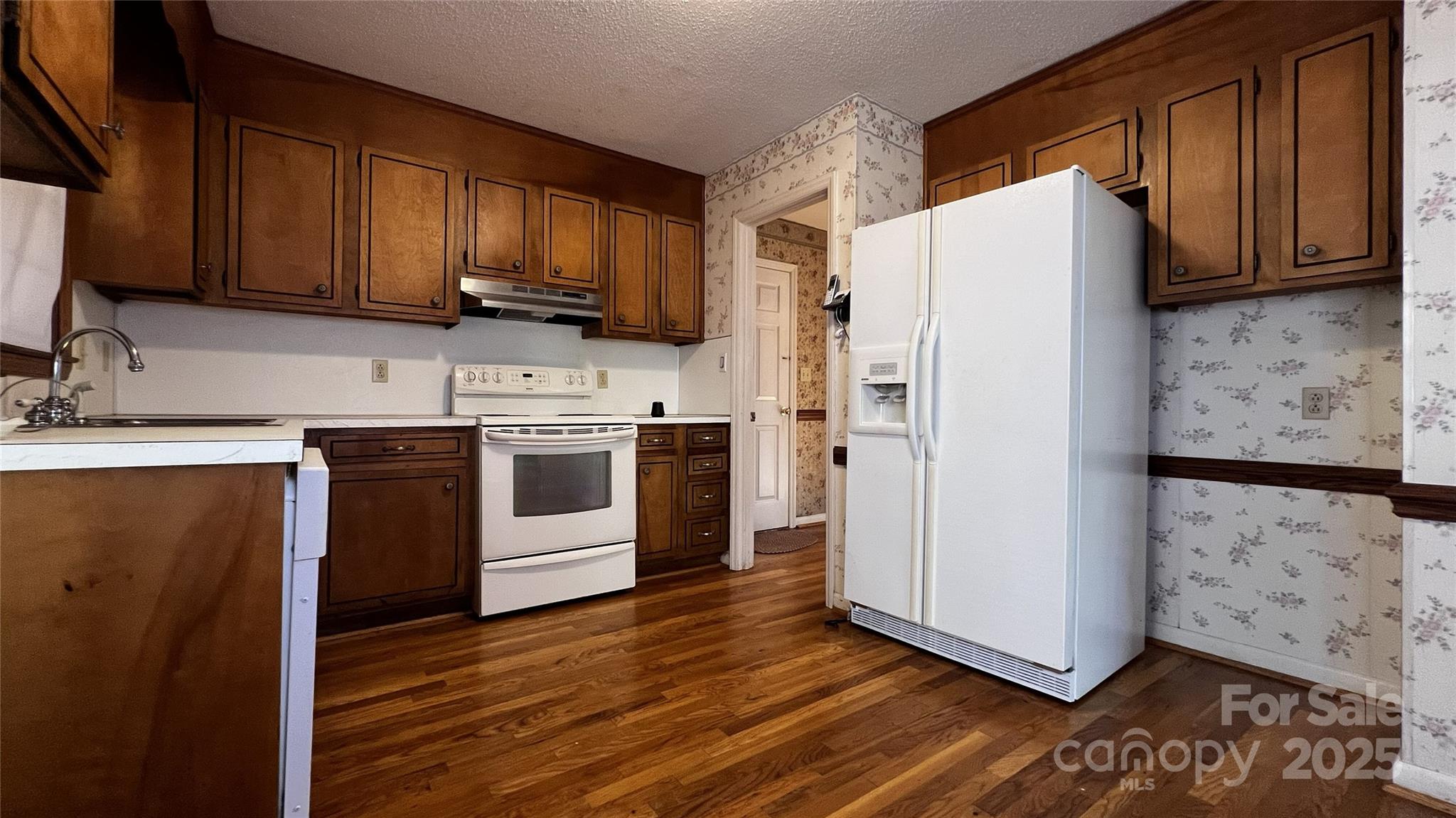 1325 Leolillie Lane Charlotte, NC 28216 - Photo 11 of 35 a kitchen with stainless steel appliances granite countertop a refrigerator a stove top oven a sink and dishwasher with wooden floor