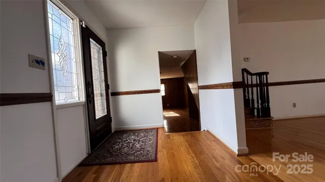 a view of hallway with wooden floor