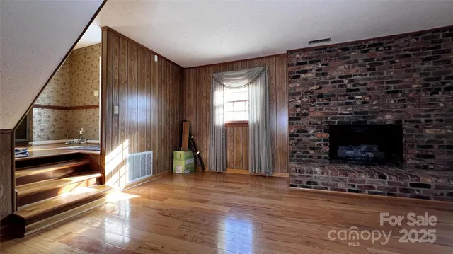 a view of room with window and wooden floor