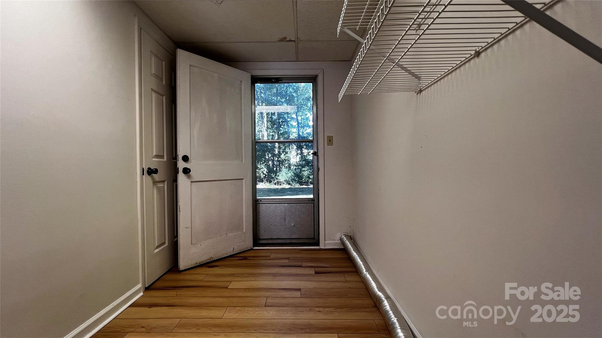 1325 Leolillie Lane Charlotte, NC 28216 - Photo 20 of 35 a view of a hallway with wooden floor and entryway