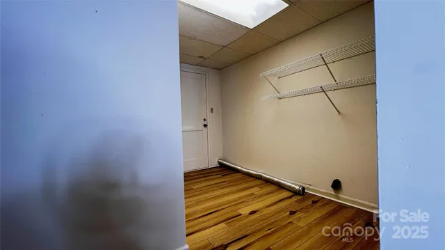 a view of a hallway with wooden floor and entryway