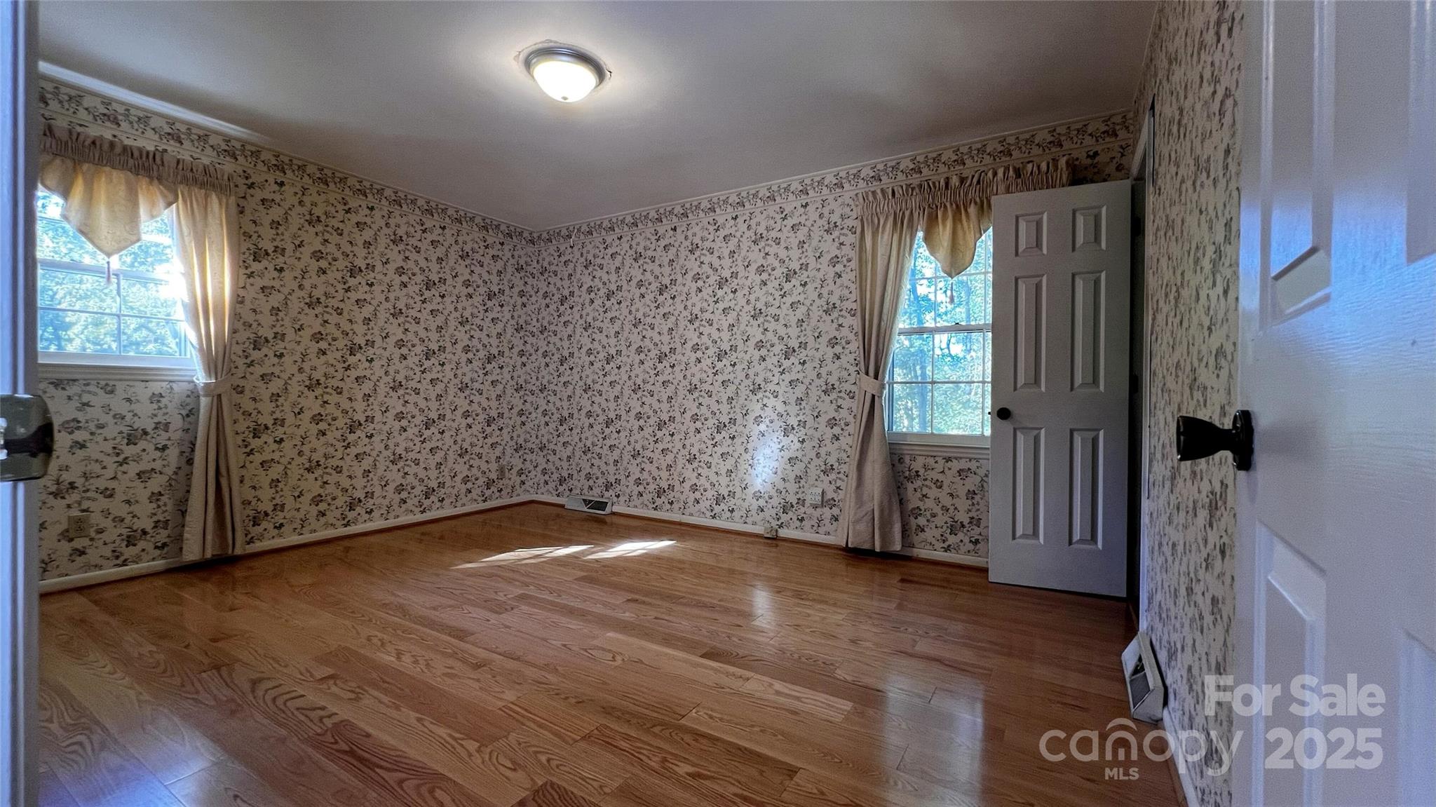 1325 Leolillie Lane Charlotte, NC 28216 - Photo 24 of 35 a view of an empty room with wooden floor and a window