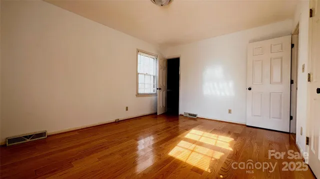 a view of an empty room with closet area