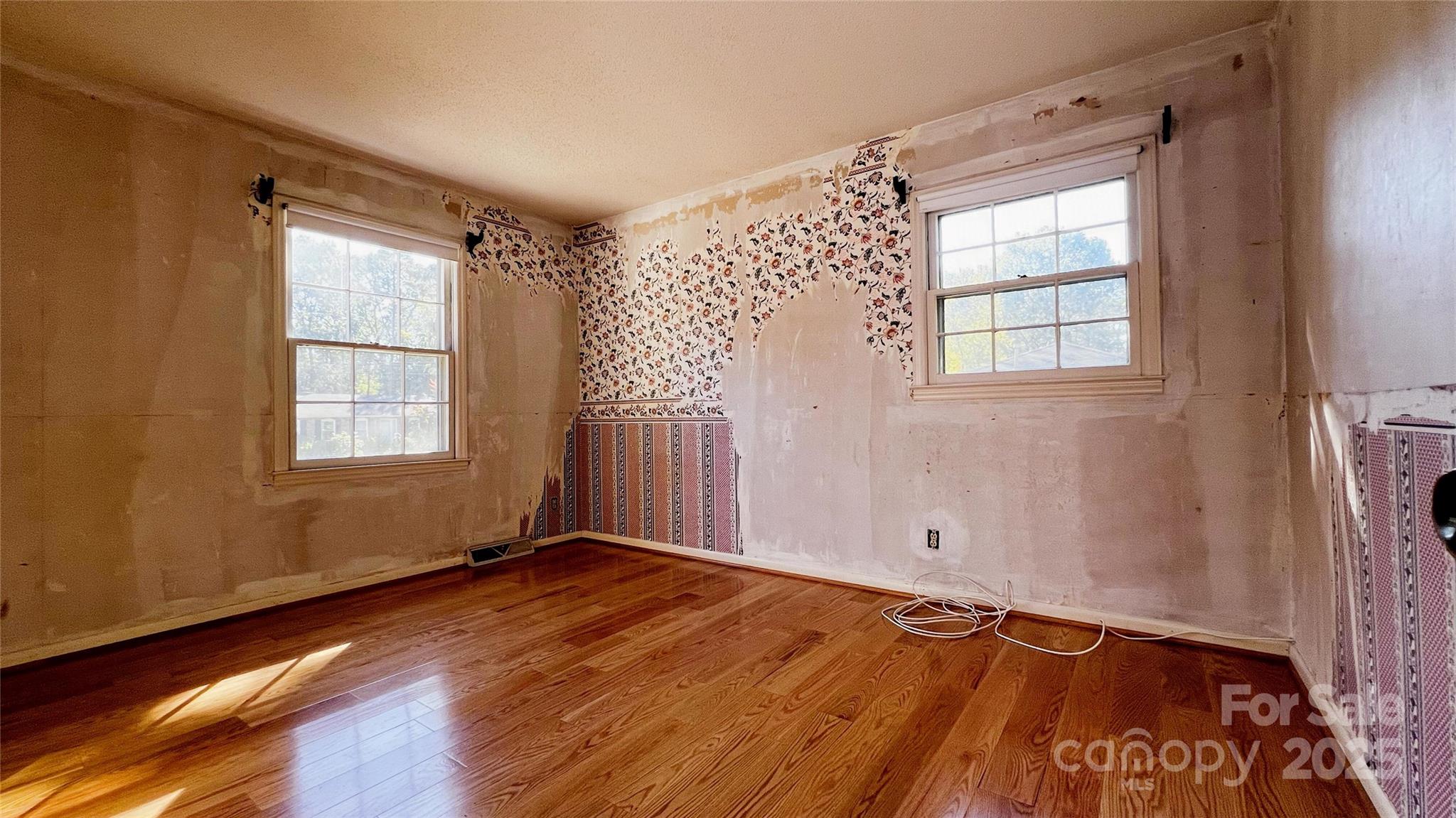 1325 Leolillie Lane Charlotte, NC 28216 - Photo 29 of 35 a view of an empty room with wooden floor and a window