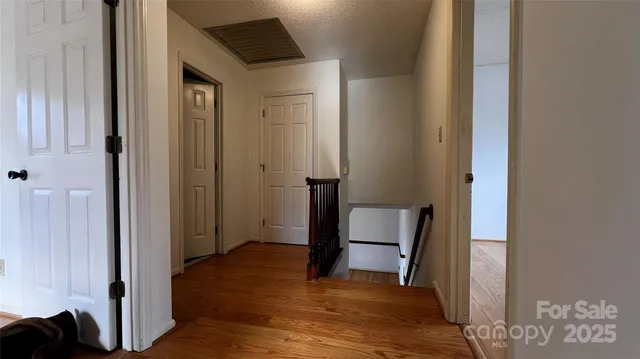 a view of a room with wooden floor and window