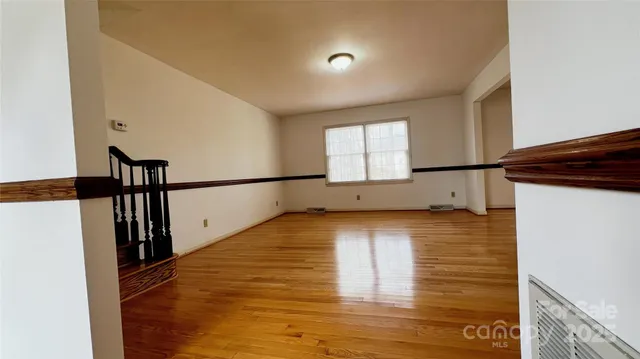 a view of a room with wooden floor