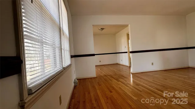 a view of a walk in closet with wooden floor