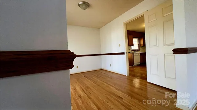a view of a bedroom with wooden floor and cabinets