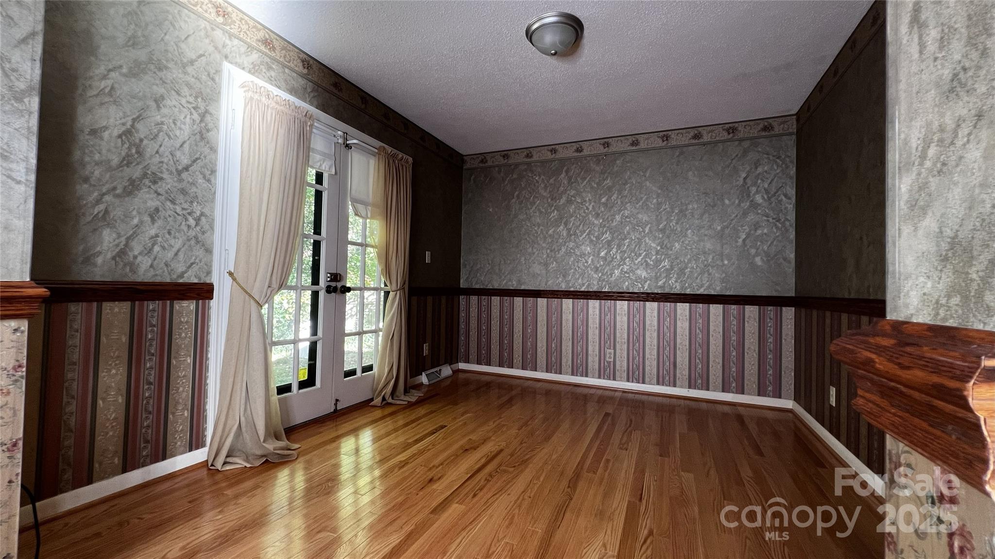 1325 Leolillie Lane Charlotte, NC 28216 - Photo 8 of 35 a view of a room with wooden floor and windows