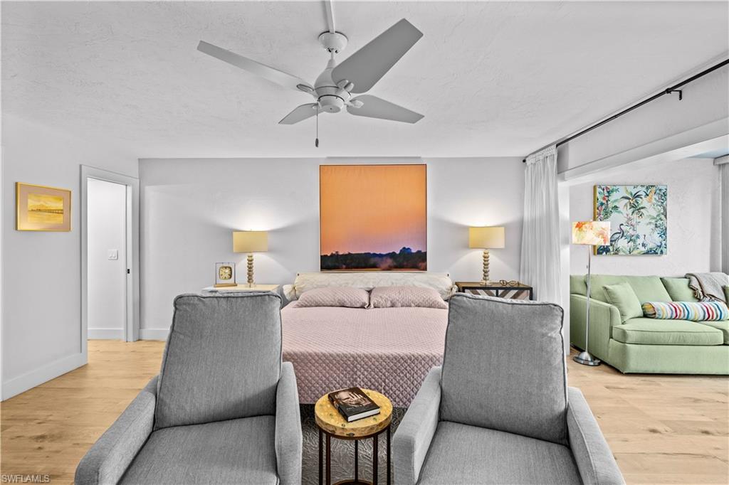 377 Vanderbilt Beach Road, Unit 102 Naples, FL 34108 - Photo 7 of 19 a living room with furniture and a large window
