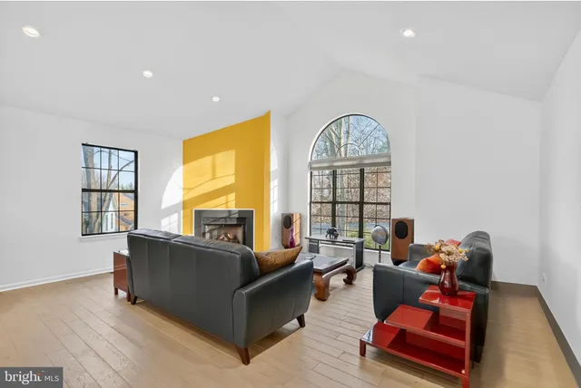 a living room with furniture a window and a fireplace