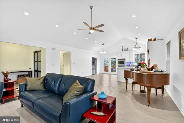 a living room with furniture and kitchen view