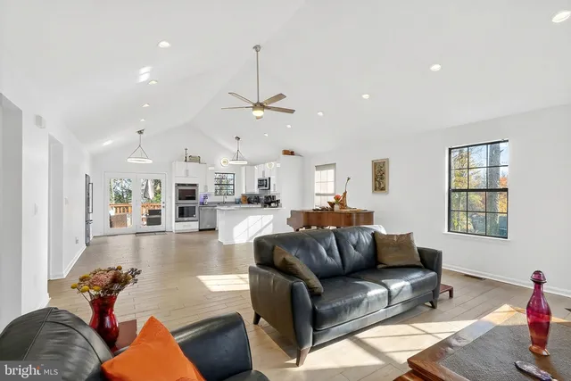 a kitchen with granite countertop white cabinets and stainless steel appliances