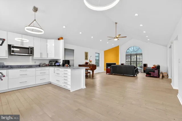 a kitchen with granite countertop a sink stainless steel appliances and cabinets