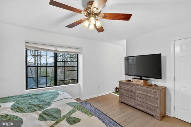 a bathroom with a granite countertop sink toilet a mirror and a tub