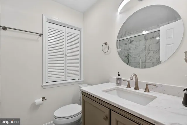 a living room with lots of furniture and view of kitchen