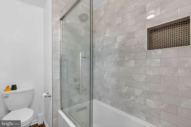 a living room with a couch and wooden floor