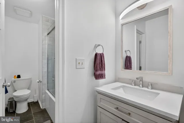 a view of a workspace with furniture and a flat screen tv