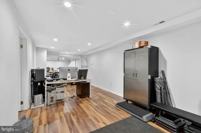 a room with gym equipment and a view of living room