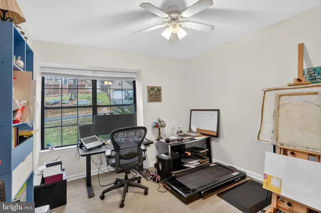 a view of a roof deck with couches and wooden floor