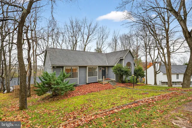 a front view of house with yard and trees around