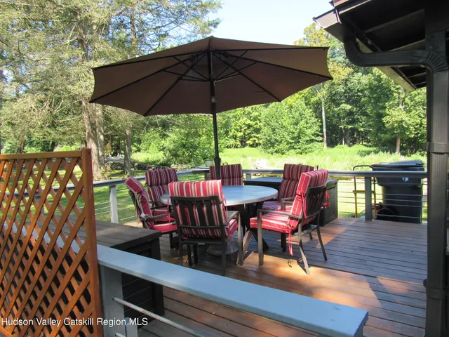 a view of a chairs and table in the patio with a small yard