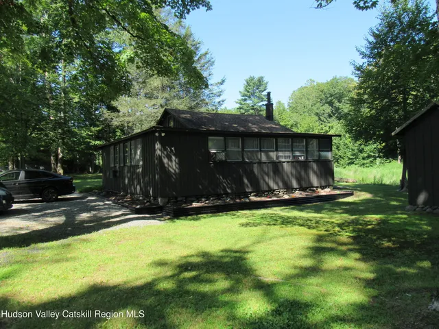 a view of a backyard with a small cabin