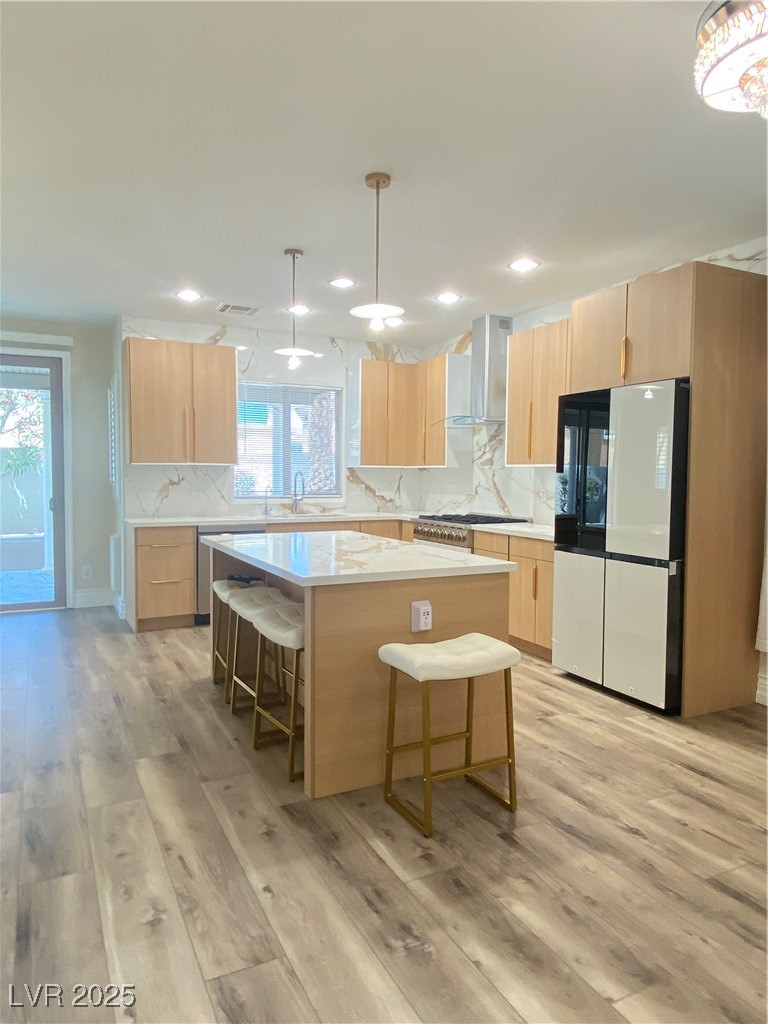 172 Tall Ruff Drive Las Vegas, NV 89148 - Photo 13 of 94 Kitchen with refrigerator, extractor fan, light brown cabinets, a center island, and recessed lighting