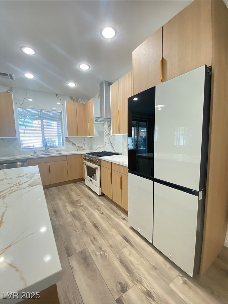 172 Tall Ruff Drive Las Vegas, NV 89148 - Photo 14 of 94 Kitchen featuring exhaust hood, range, refrigerator, light brown cabinetry, and a sink