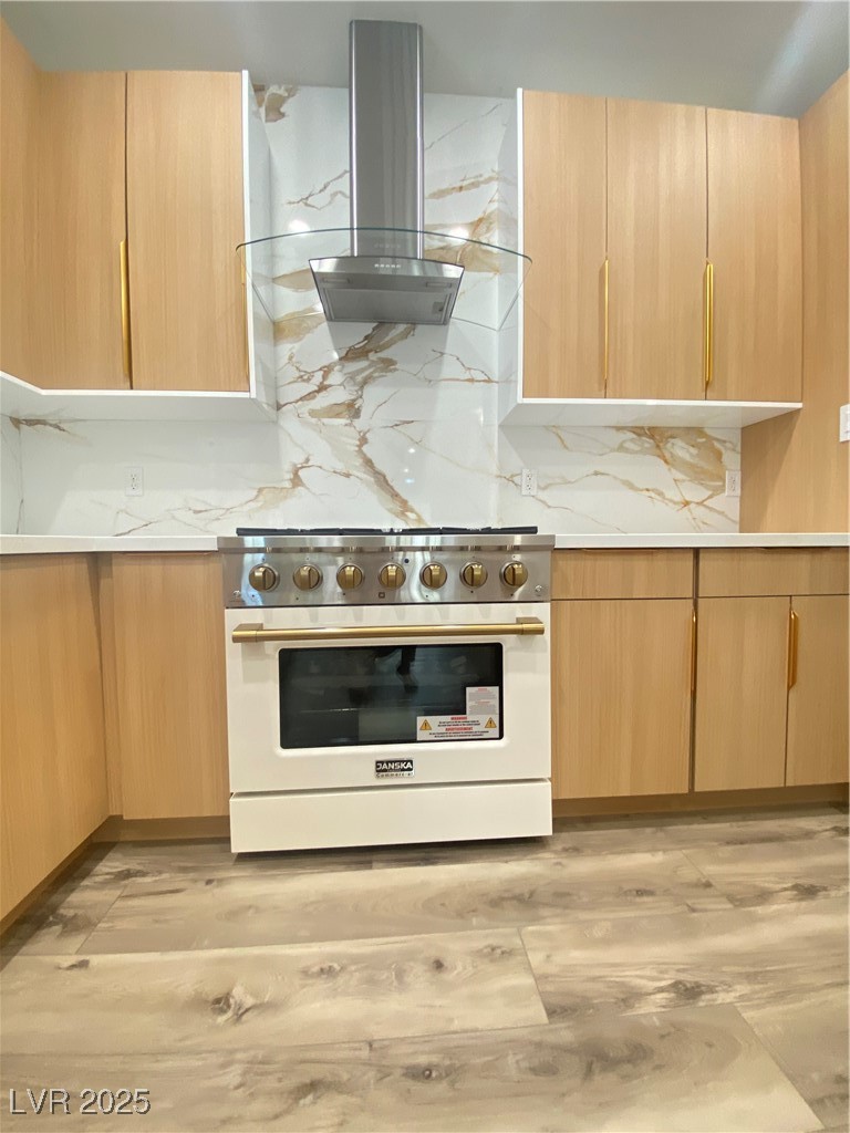 172 Tall Ruff Drive Las Vegas, NV 89148 - Photo 15 of 94 Kitchen featuring high end stainless steel range oven, extractor fan, light brown cabinets, and light countertops