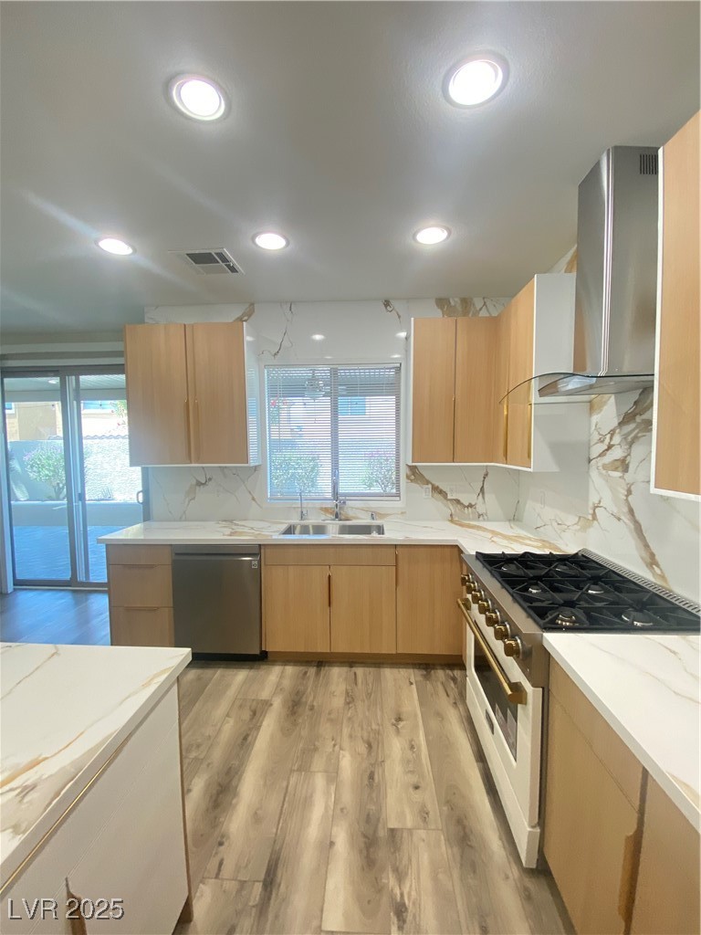 172 Tall Ruff Drive Las Vegas, NV 89148 - Photo 16 of 94 Kitchen featuring dishwashing machine, stove, exhaust hood, light brown cabinets, and a sink