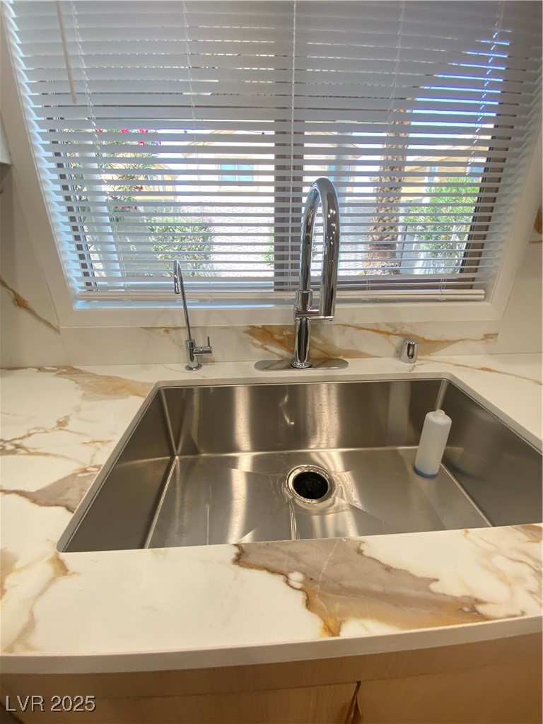 172 Tall Ruff Drive Las Vegas, NV 89148 - Photo 17 of 94 Kitchen view of a sink and light stone countertops