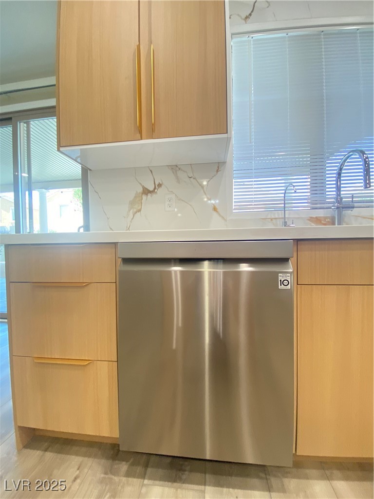 172 Tall Ruff Drive Las Vegas, NV 89148 - Photo 18 of 94 Kitchen with stainless steel dishwasher, light brown cabinets, modern cabinets, and light countertops