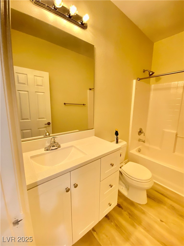 172 Tall Ruff Drive Las Vegas, NV 89148 - Photo 24 of 94 Downstairs Full bath featuring wood finished floors, vanity, toilet, and shower / washtub combination