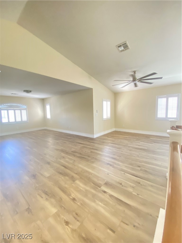 172 Tall Ruff Drive Las Vegas, NV 89148 - Photo 29 of 94 Unfurnished living room with ceiling fan, baseboards, light wood-type flooring, and vaulted ceiling