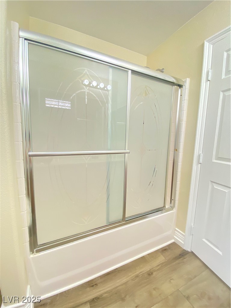 172 Tall Ruff Drive Las Vegas, NV 89148 - Photo 41 of 94 Jack and Jill bathroom featuring shower / bath combination with glass door and wood finished floors