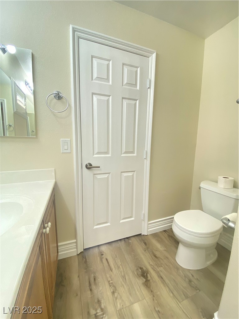 172 Tall Ruff Drive Las Vegas, NV 89148 - Photo 42 of 94 Jack and Jill bath with vanity, toilet, wood finished floors, and baseboards