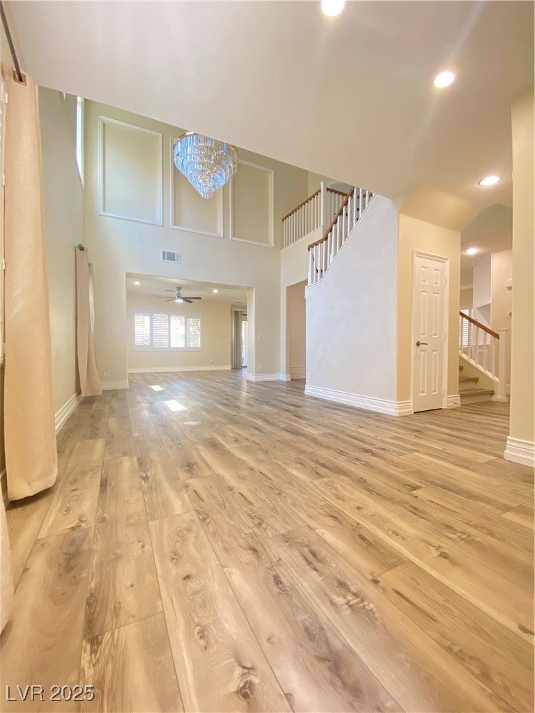 172 Tall Ruff Drive Las Vegas, NV 89148 - Photo 6 of 94 front door enter into great room with light wood-style floors, stairs, a ceiling fan, baseboards, and recessed lighting