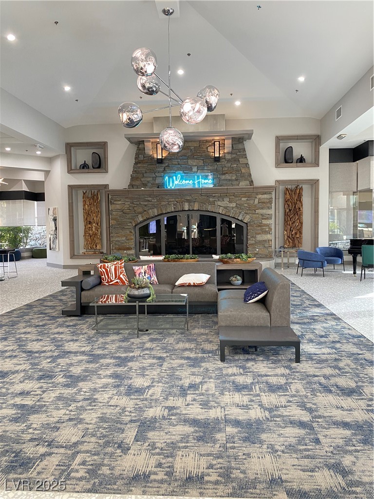 172 Tall Ruff Drive Las Vegas, NV 89148 - Photo 65 of 94 Carpeted living area with a stone fireplace, recessed lighting, and visible vents