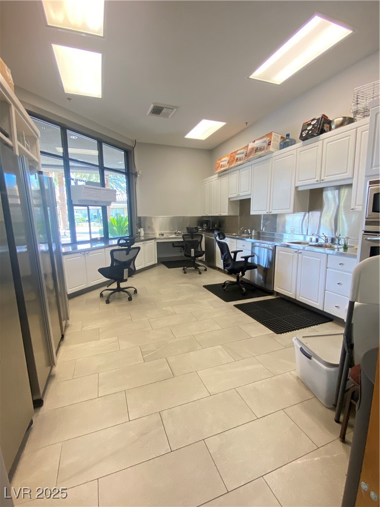 172 Tall Ruff Drive Las Vegas, NV 89148 - Photo 72 of 94 Kitchen with visible vents, wall oven, and white cabinetry